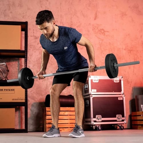 Athlète soulevant une barre légère Hop Sport lors d'un exercice