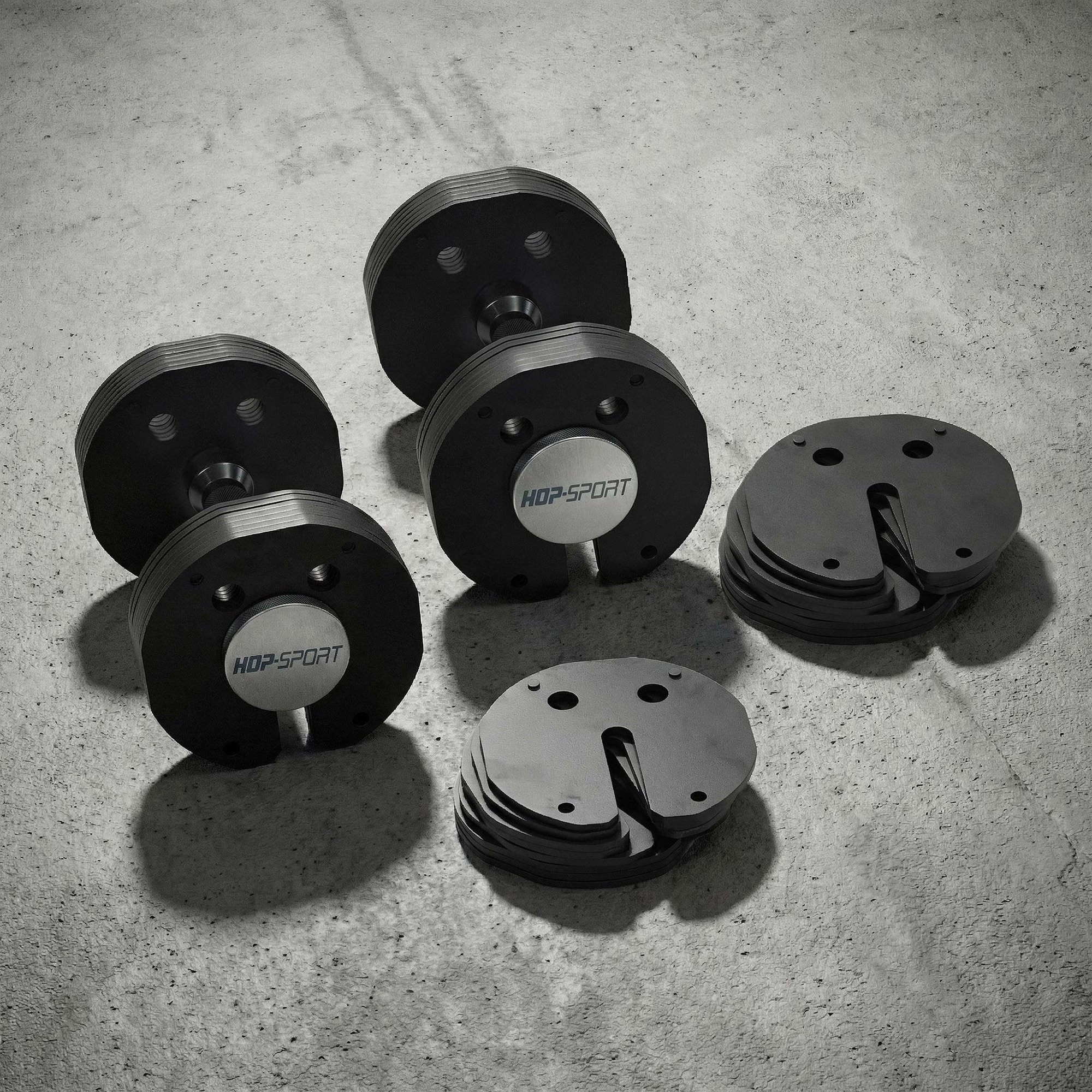 Haltère compact au design moderne avec extrémités plates pour un gain de place en home gym.