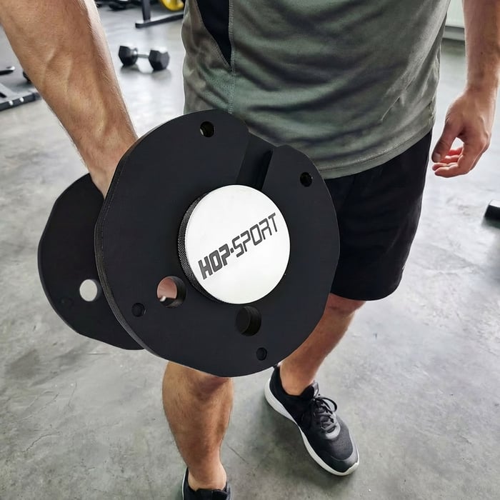 Poignée striée antidérapante de 32 mm de diamètre pour une prise en main sécurisée de l'haltère.